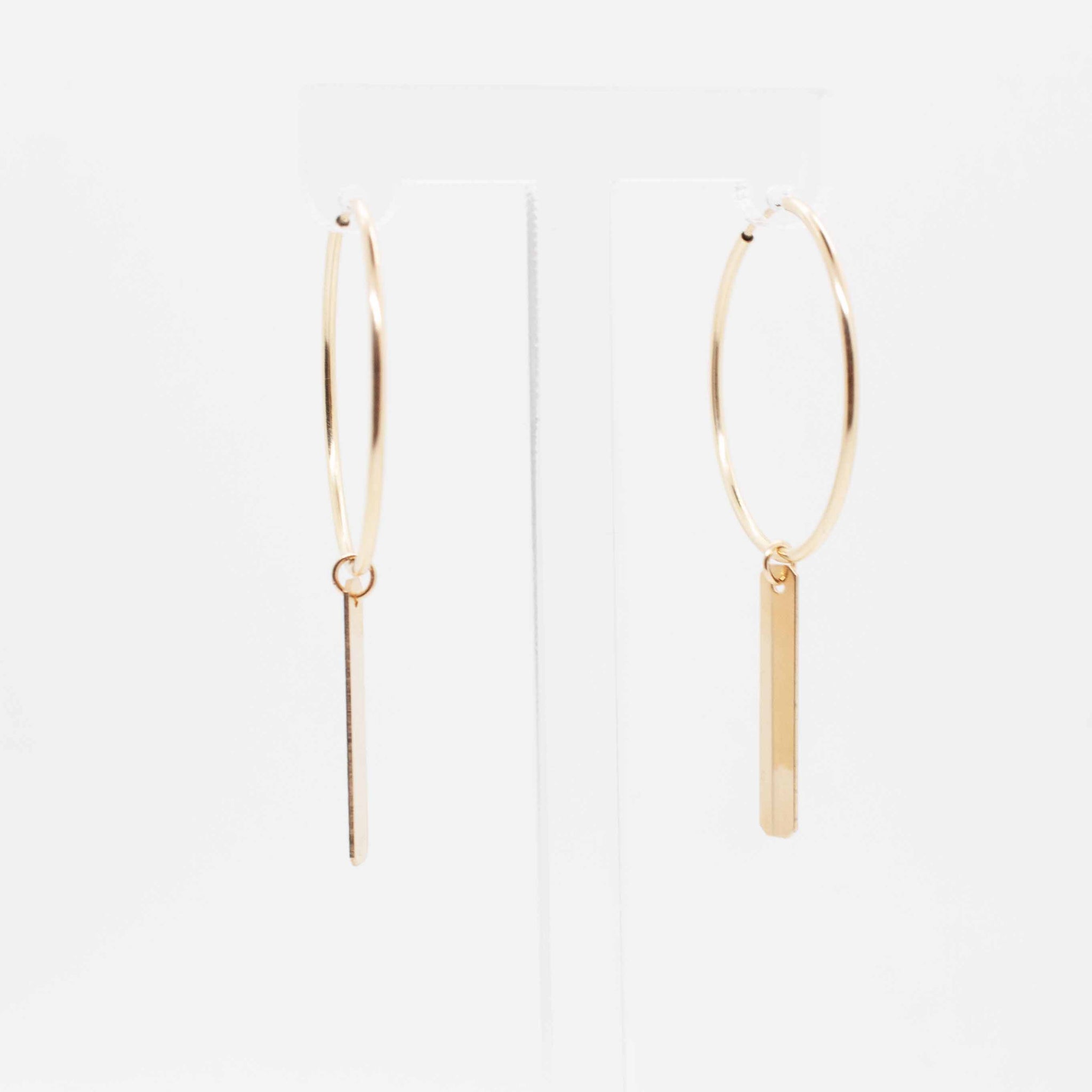 A sleek and sophisticated take on your everyday gold hoop, these are some sexy beasts.  30mm gold filled hoop earrings with gold tag charms. Made in Toronto.