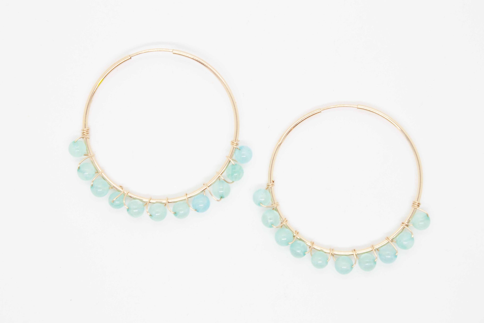 Bodacious ear candy to crank up your Zoom calls this summer!  40mm gold filled hoop earrings and aqua beads wrapped with gold wire. Handmade in Toronto.