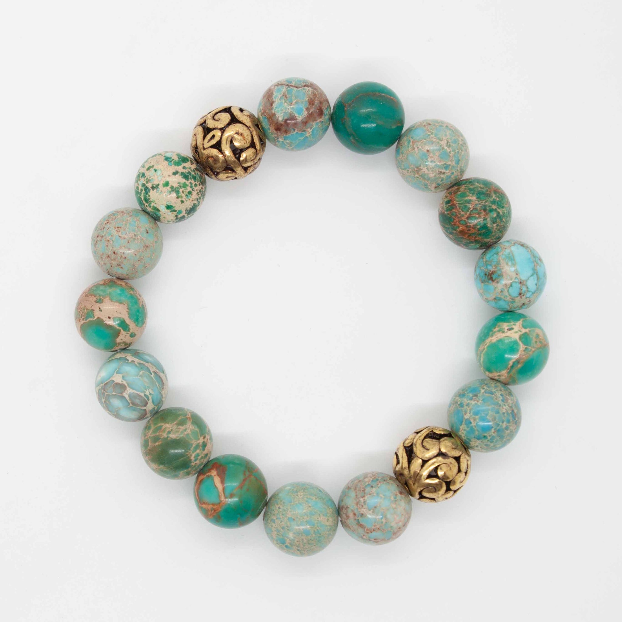 Wear this bracelet and be soothed by the green, aqua and turquoise colours of the ocean. 7 inch bracelet made with aquamarine and sky blue jasper beads, along with brass accents, double strung with silk elastic. Handmade in Toronto by kp jewelry co.