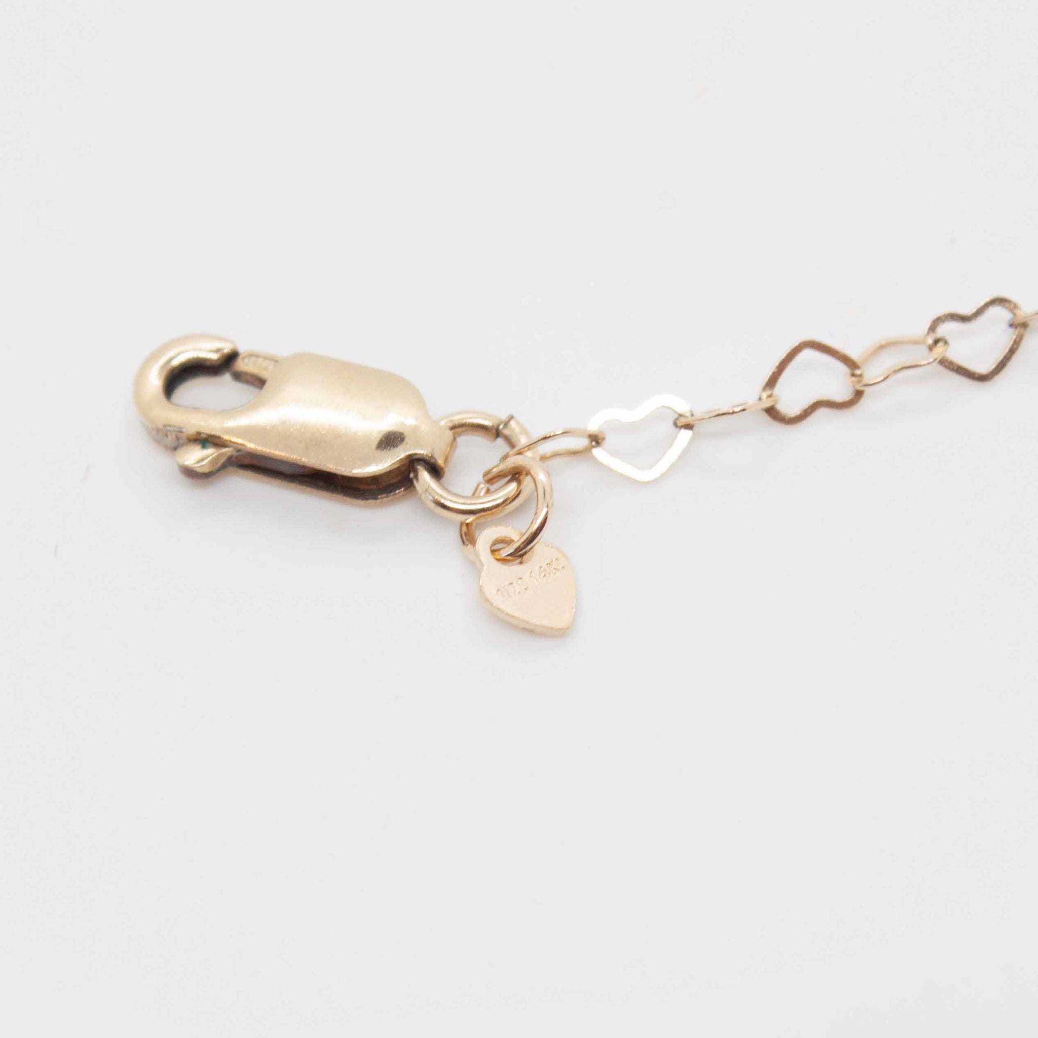 18 inch 14 karat gold filled mini heart bracelet, finished with a delicate solid heart at the clasp.