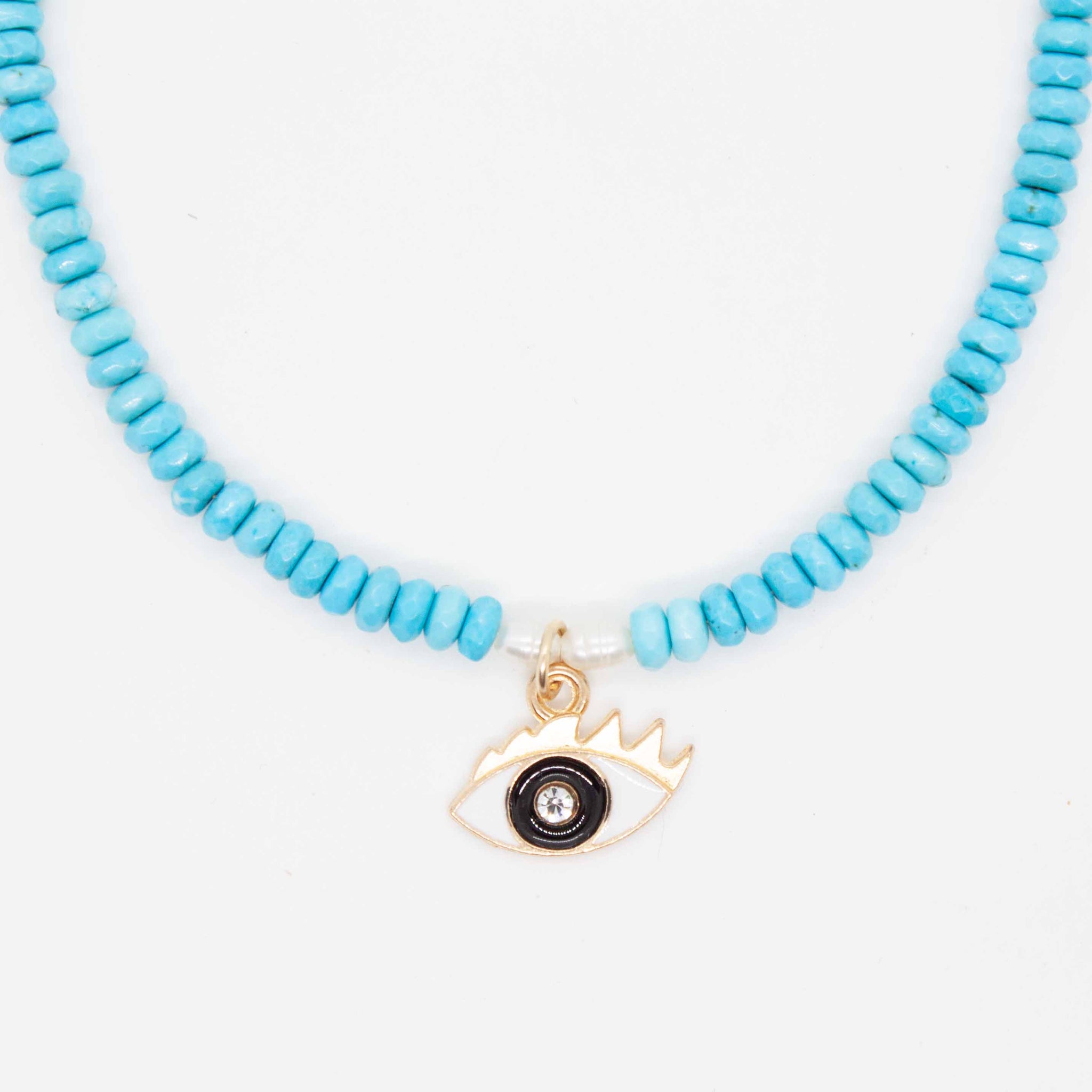 A universal symbol of protection, the evil eye talisman dates back to ancient Greece. This charm is paired with bright turquoise beads and freshwater pearls. 16" necklace beaded with synthetic, faceted turquoise beads and freshwater pearls enamel evil eye pendant with sparkly iris. Made in Toronto by kp jewelry co.
