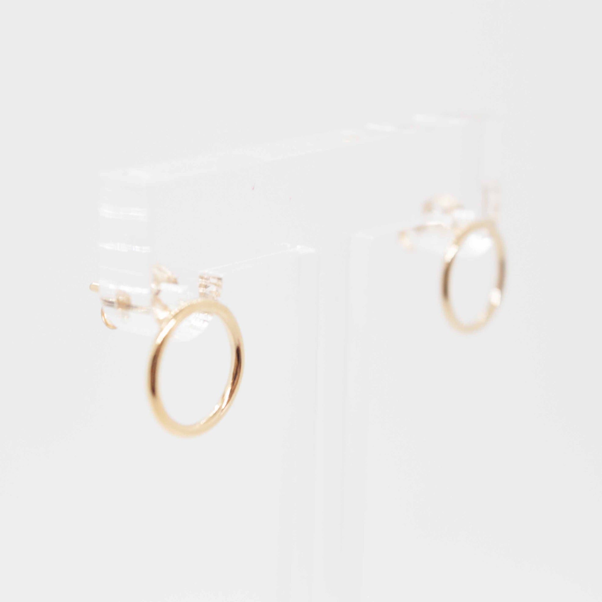 Gold circle stud earrings with butterfly backings