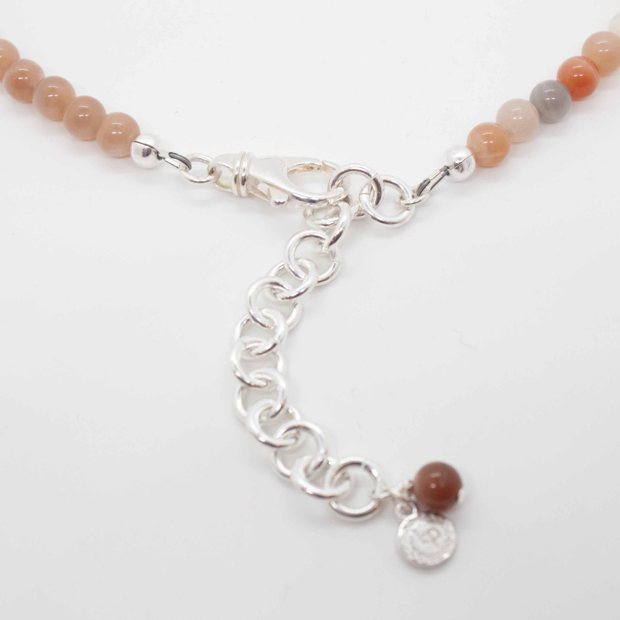 18 inch (adjustable to 20 inches) peach & mixed moonstone necklace with sterling silver hamsa charm.