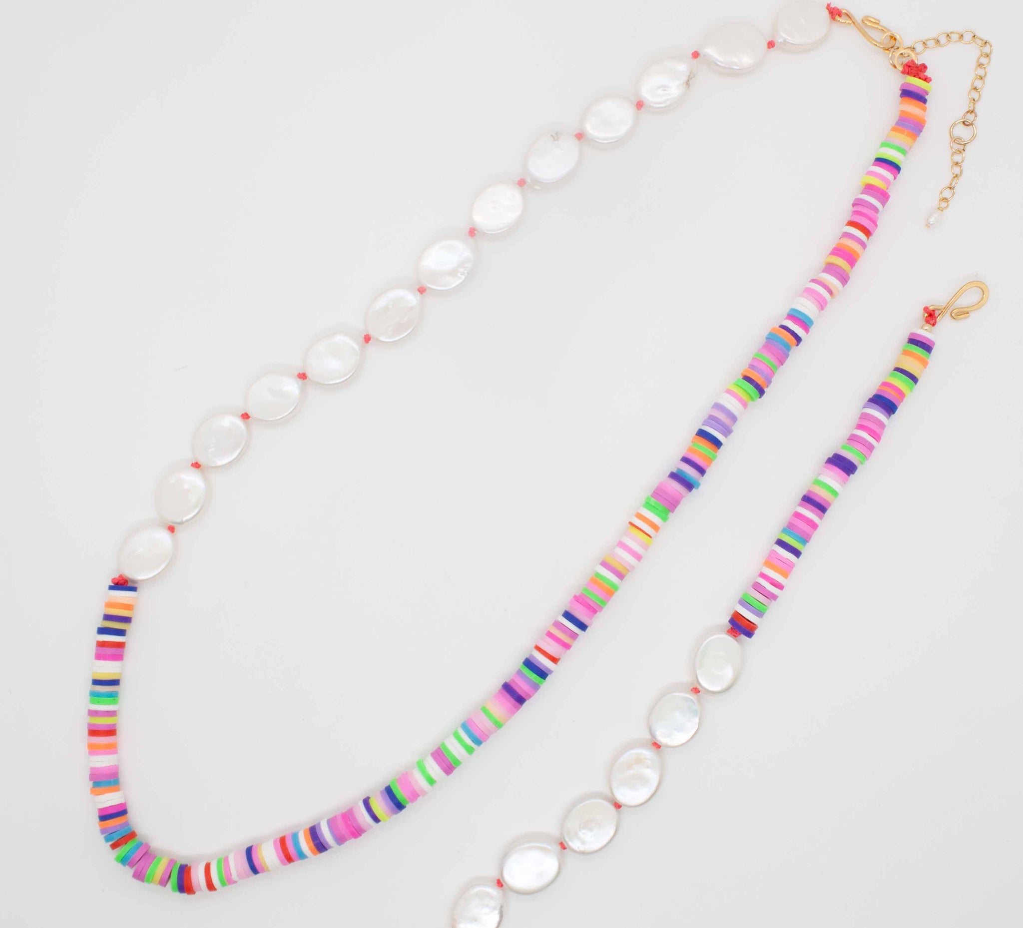 Surprise those traditional pearls with a pop of fun-loving colour! 20 inch (adjustable to 22 inches) hand knotted pearl necklace with multicolour vinyl heishi beads. Handmade in Toronto by kp jewelry co.