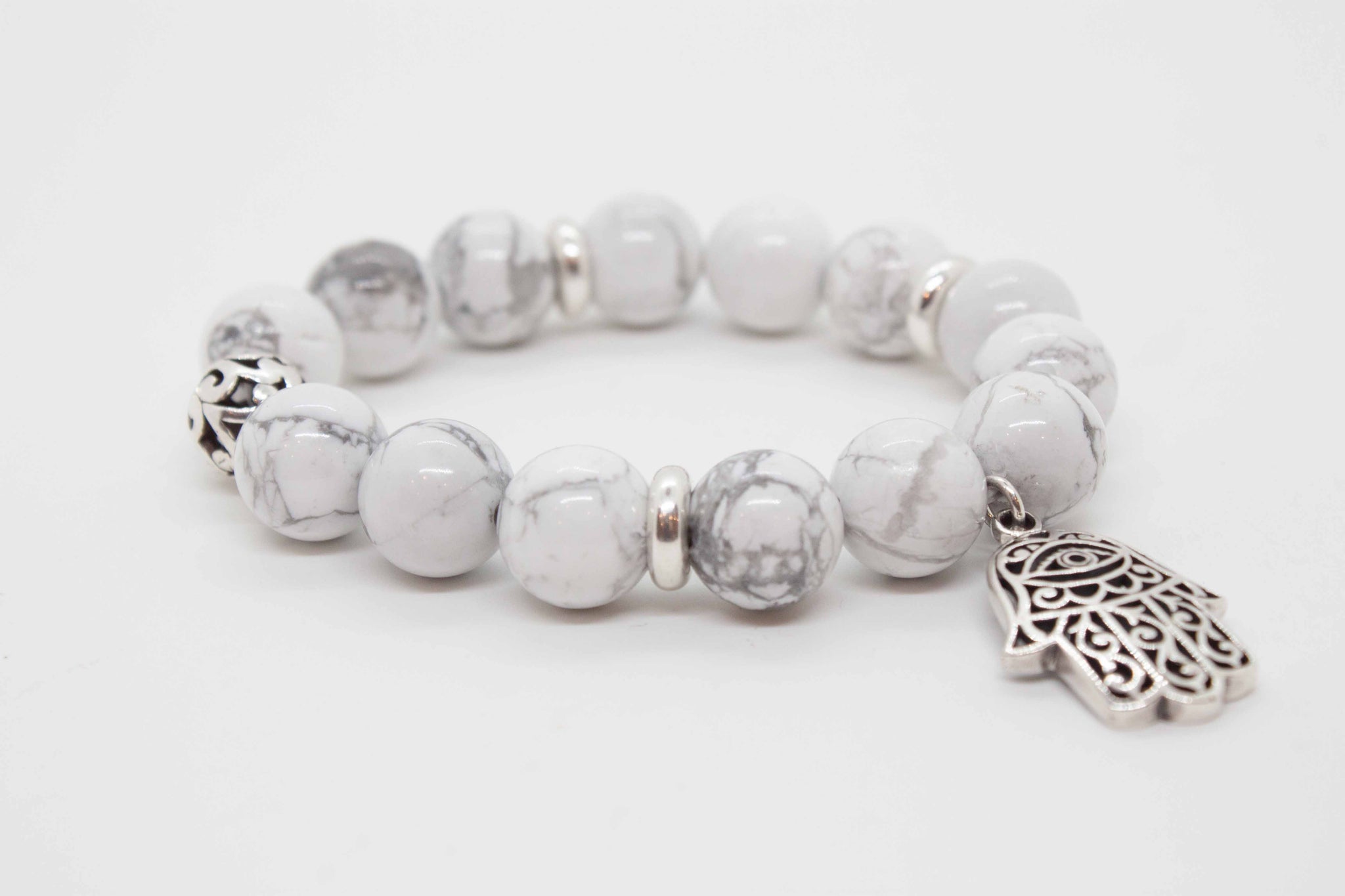 White howlite beaded bracelet with sterling silver beads and hamsa charm.