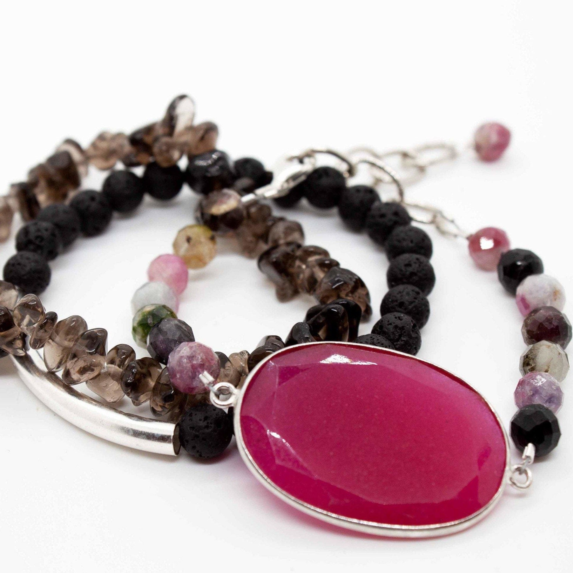 Cadence bracelet stack: 3 beaded bracelets made from rainbow tourmaline, lava, smoky quartz and sterling silver. Tourmaline bracelet has large ruby pendant and adjustable sterling silver lobster clasp.
