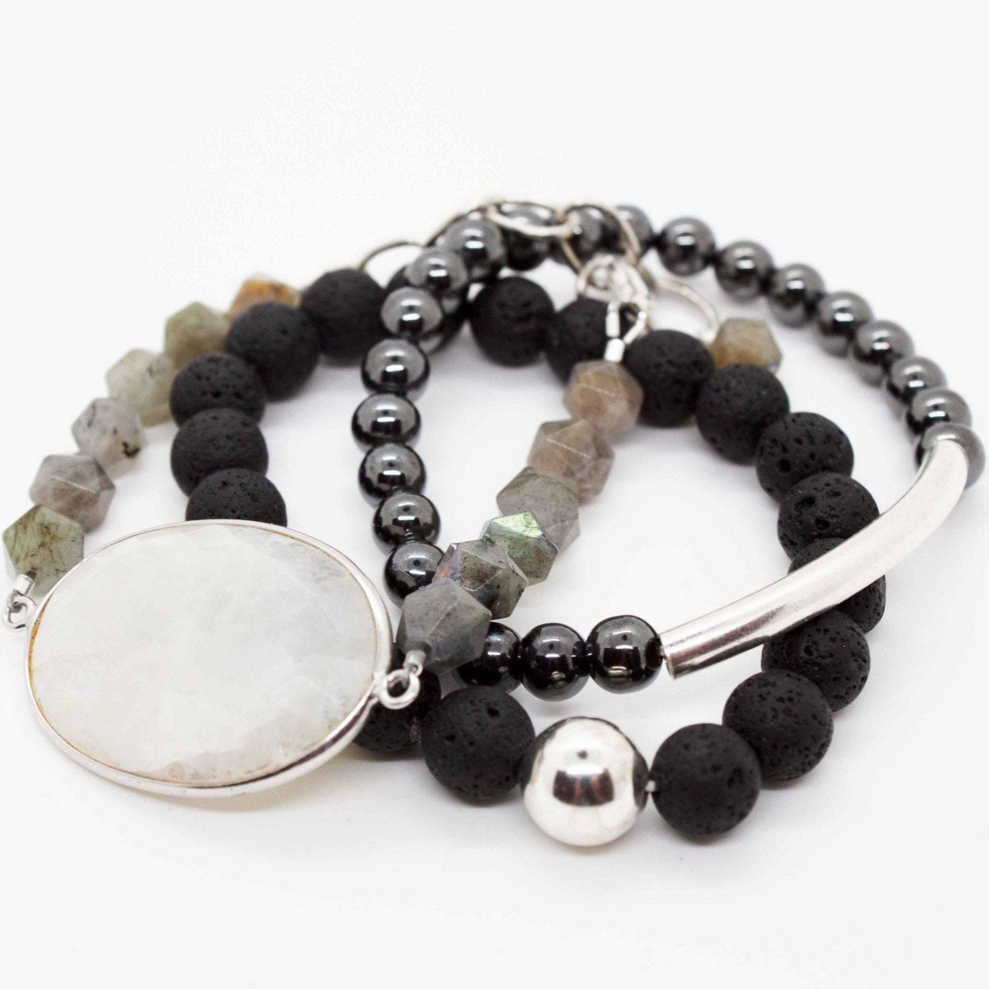 Cadence bracelet stack: 3 beaded bracelets made from labradorite, lava, hematite and sterling silver beads. Labradorite bracelet has large rainbow moonstone pendant and adjustable sterling silver lobster clasp.
