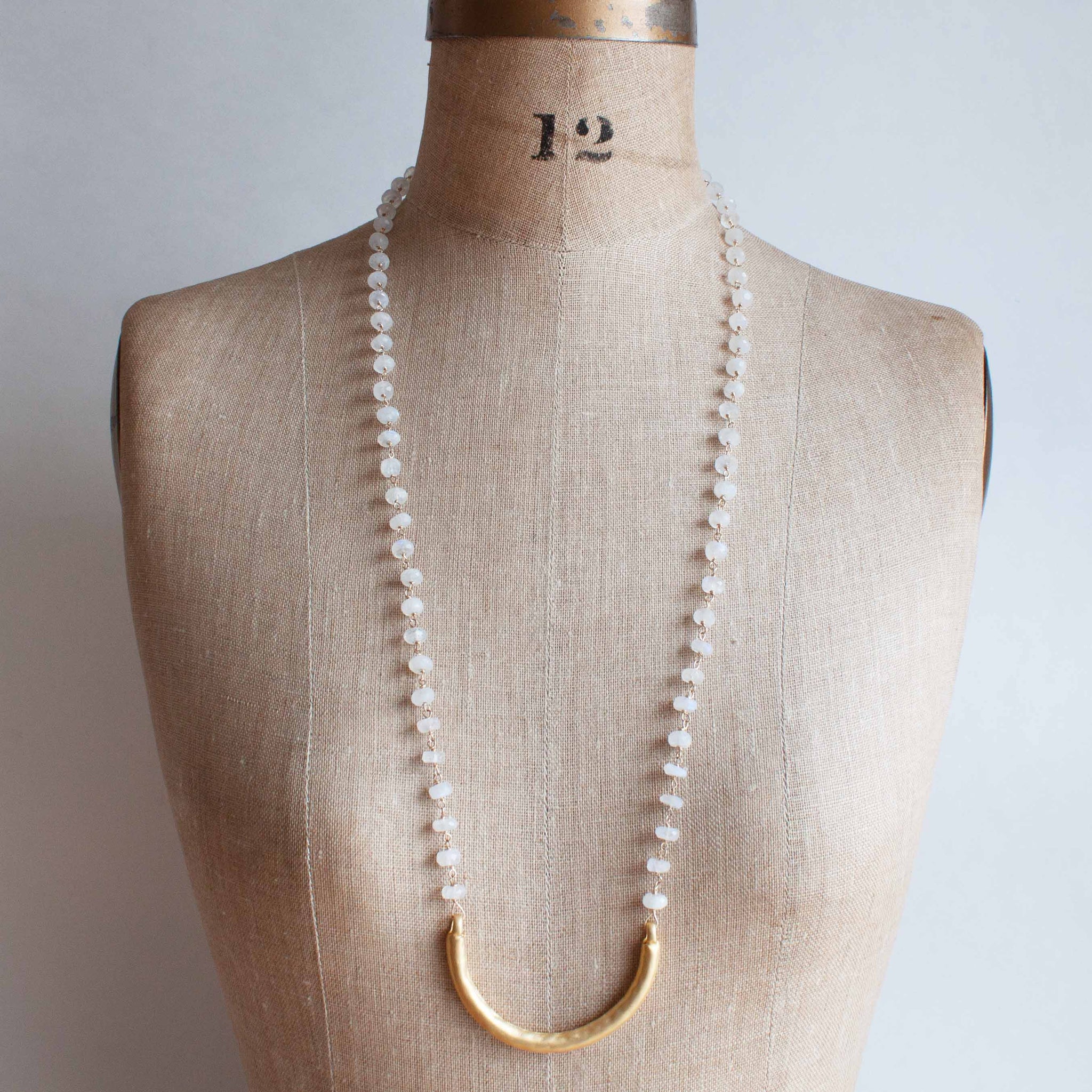 This delicate moonstone necklace ends perfectly with a well placed golden 'smile.' A versatile piece for wearing with your summer whites or winter greys. 30 inch necklace with gold wire wrapped faceted moonstone beads and gold vermeil pendant. Handmade in Toronto by kp jewelry co.