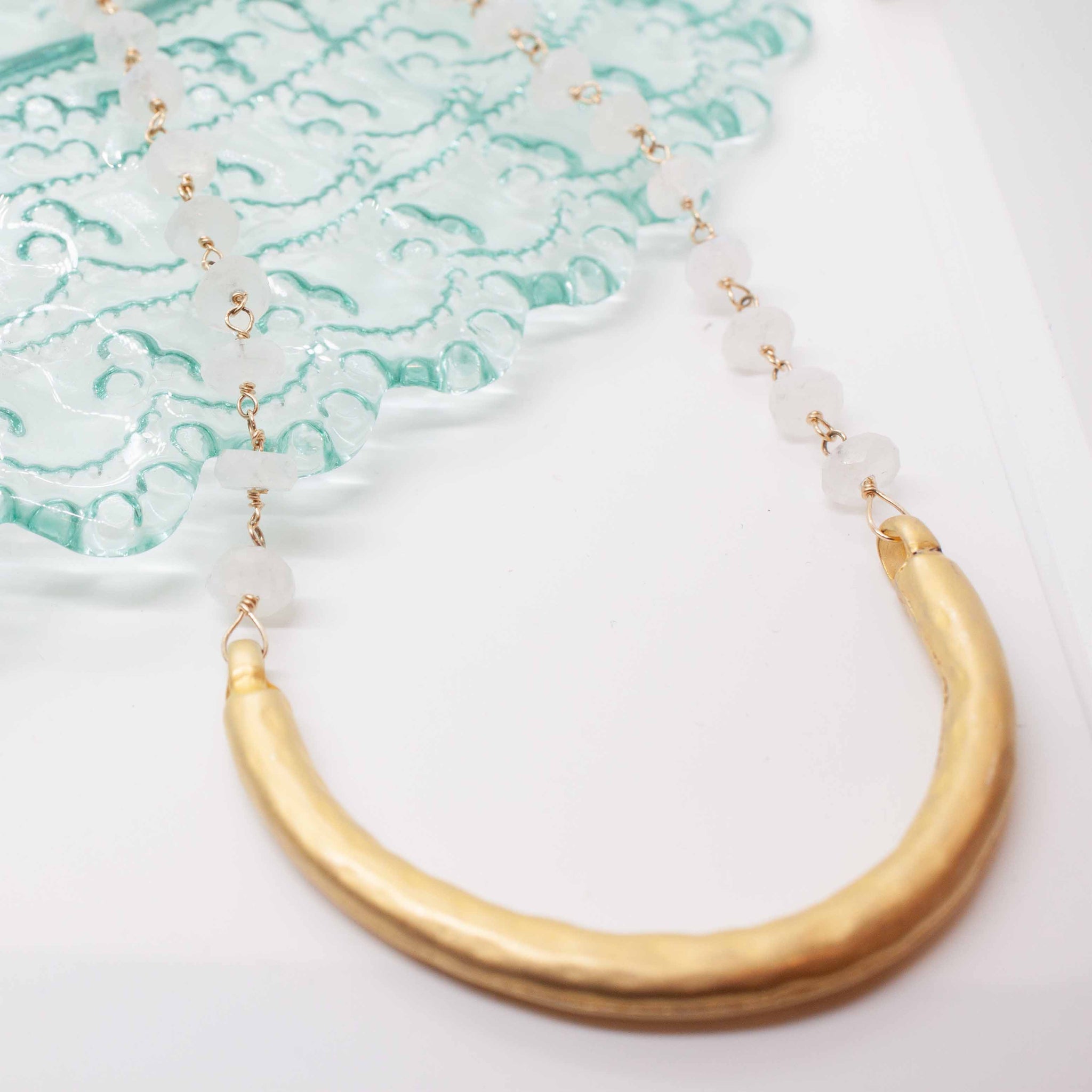 This delicate moonstone necklace ends perfectly with a well placed golden 'smile.' A versatile piece for wearing with your summer whites or winter greys. 30 inch necklace with gold wire wrapped faceted moonstone beads and gold vermeil pendant. Handmade in Toronto by kp jewelry co.