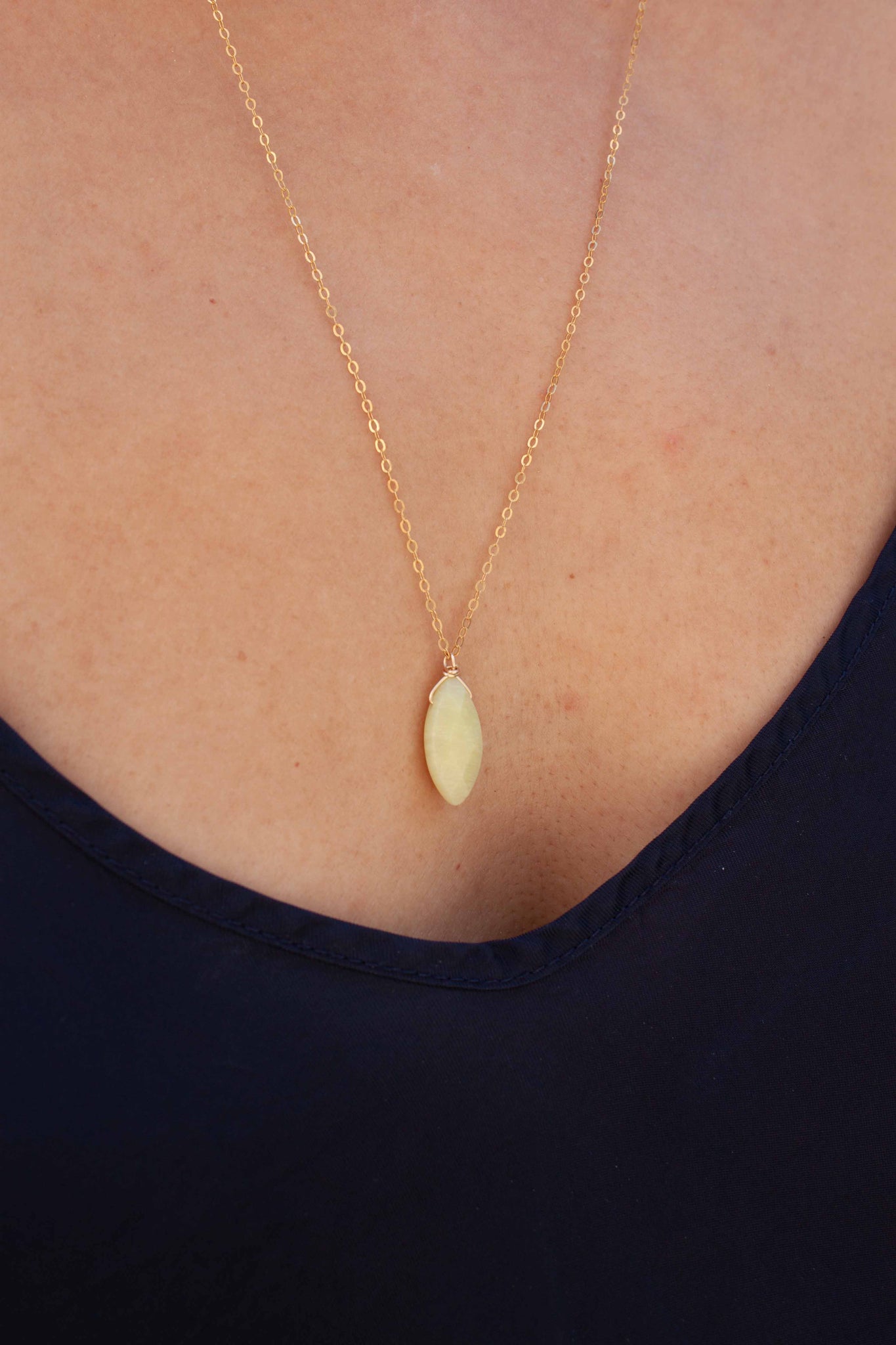 A unique 'pop' of lemon-lime colour to complement your summer whites (or blues, or pinks, or yellows....)! Gold filled necklace with olive jade charm, wrapped in 14 karat gold wire. Handmade in Toronto by kp jewelry co.
