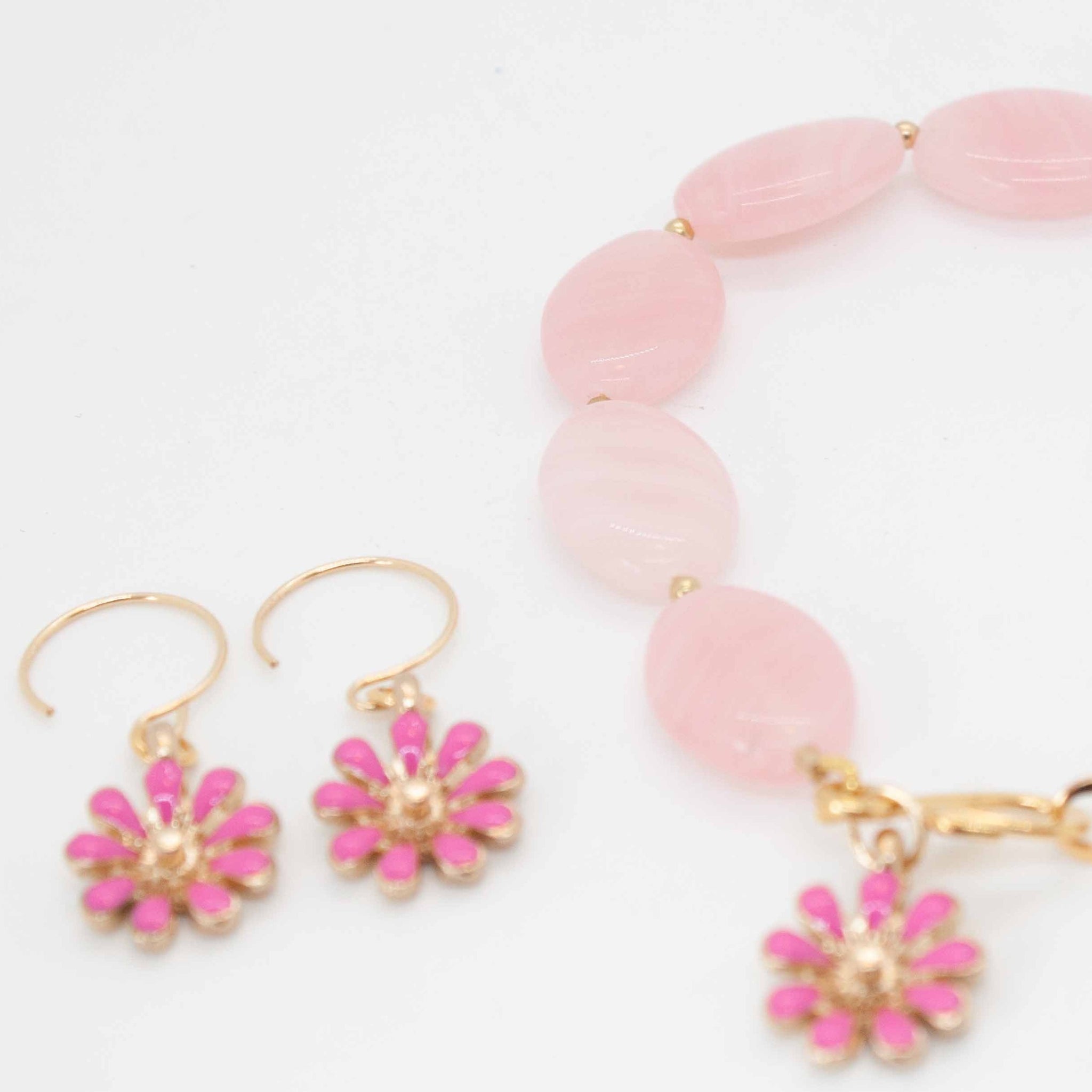 Wear spring on your wrist and ears with these delightful traditional Czech glass beads and matching daisy charms!  7 1/4 inch Czech glass beaded bracelet and gold filled earrings with blushing pink daisy enamel charms. Handmade in Toronto by kp jewelry co.