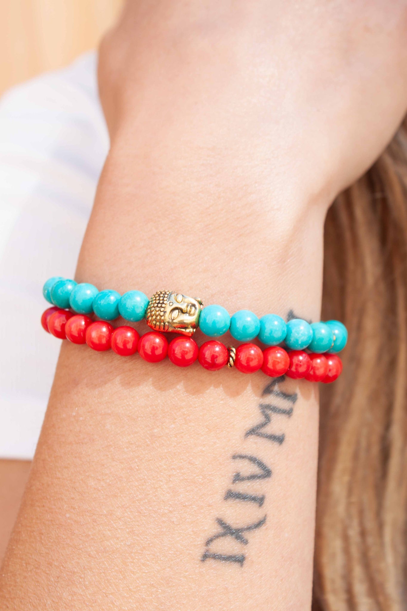 Our summer version of our best-selling buddha bracelet stack! Coral and turquoise complement each other beautifully in this fun yet soothing wristlet. Two 7 inch bracelets made with synthetic* turquoise & coral beads and brass buddha, double strung with silk elastic. Handmade in Toronto by kp jewelry co. *synthetic turquoise and coral are a cost efficient and sustainable alternative to the real thing. 