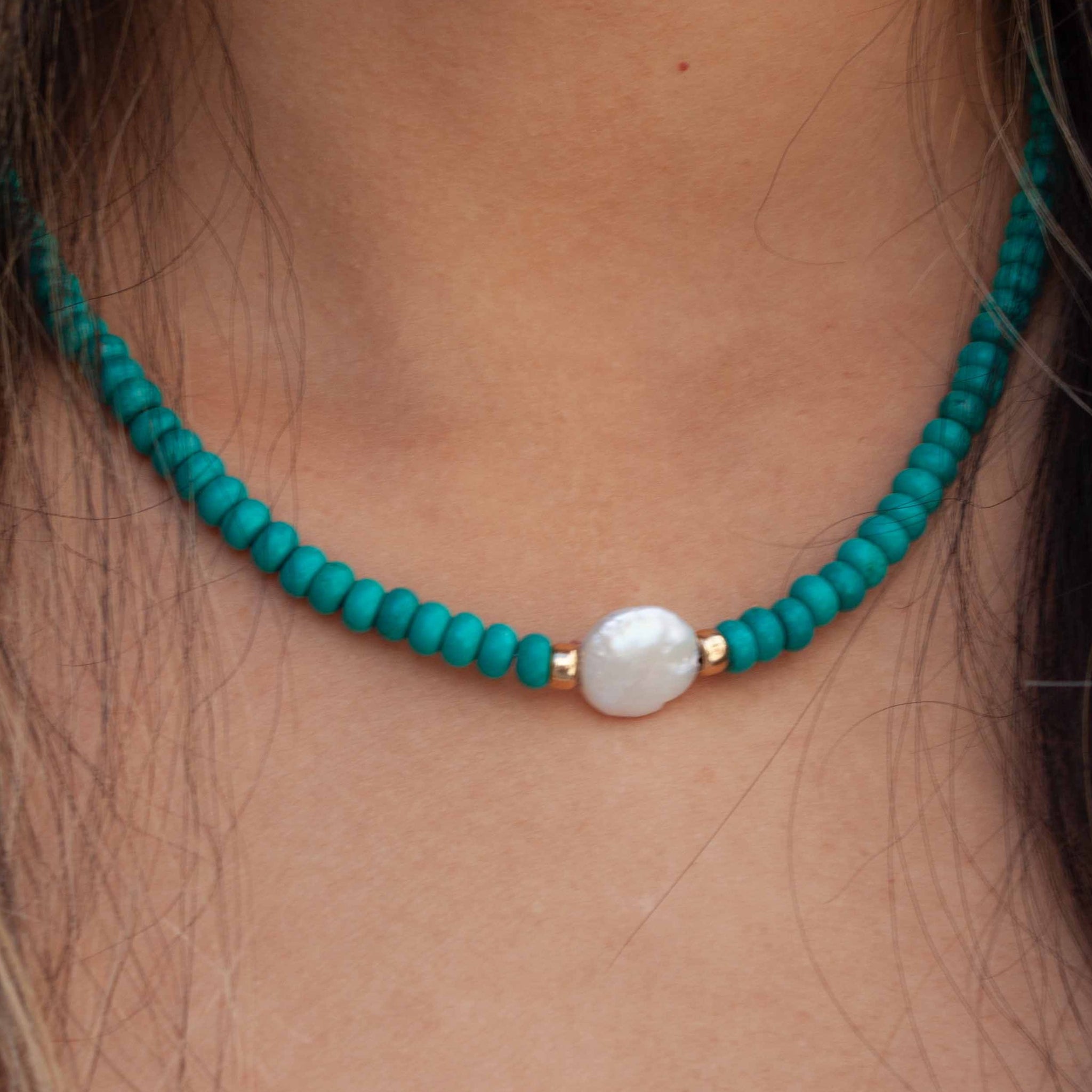A sweet turquoise necklace with a freshwater pearl focal point to add some pop to your summer whites! 16 inch (adjustable to 18 inch) synthetic* turquoise with gold beads and freshwater pearl. Handmade in Toronto by kp jewelry co. *synthetic turquoise is a cost-efficient and sustainable alternative to the real thing.