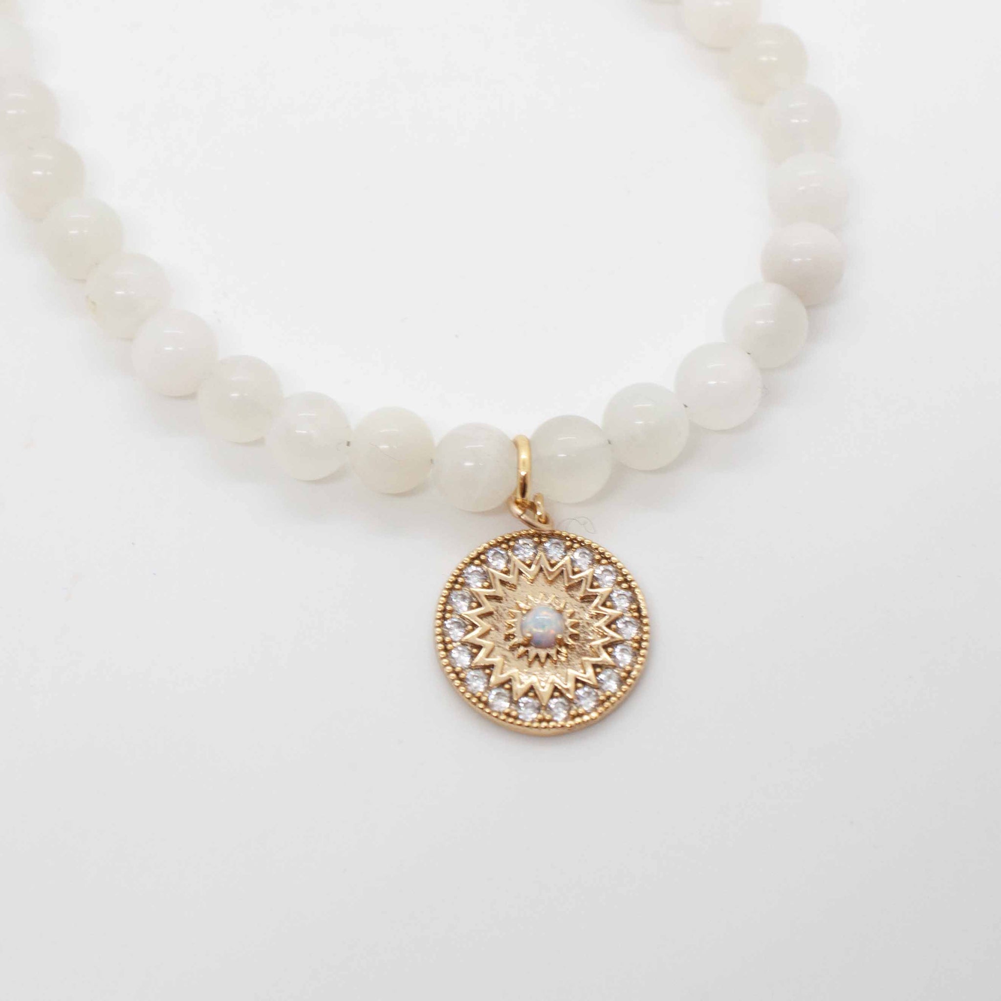 16 inch white moonstone necklace with golden Paige pendant and filigree snap clasp.